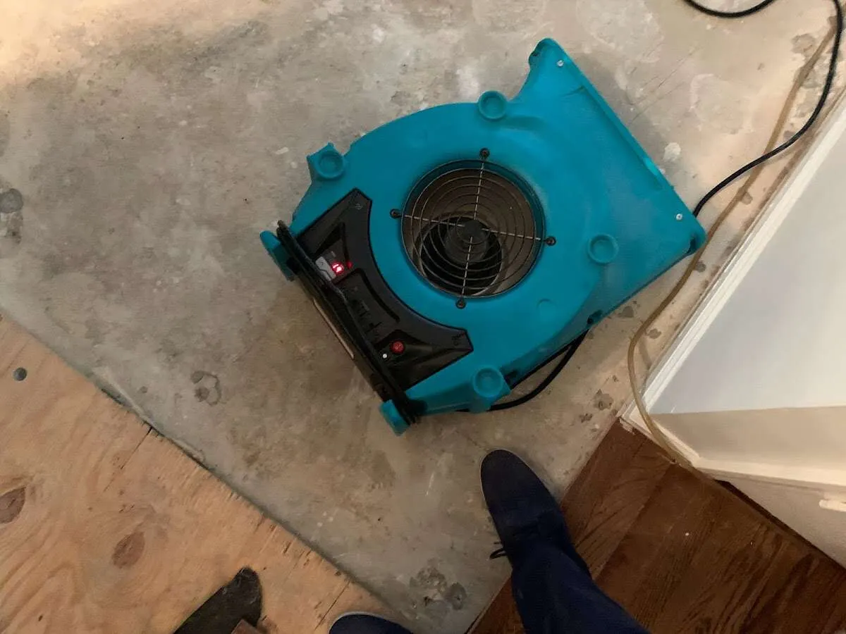 Air mover drying subfloor during Leak Detection & Repair in Great Bend